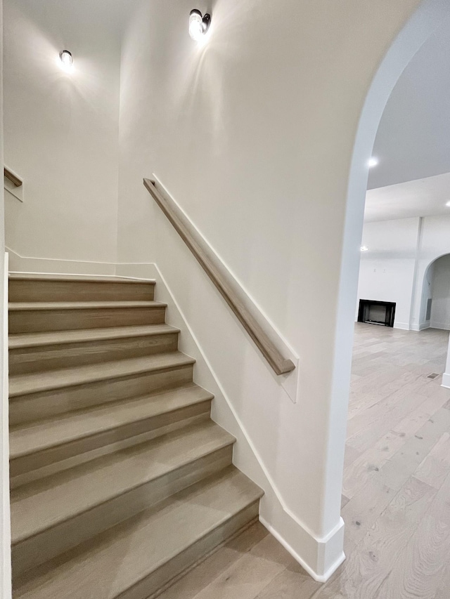 staircase with wood-type flooring