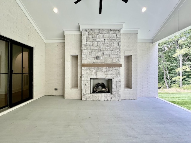 view of patio / terrace with ceiling fan and an outdoor stone fireplace