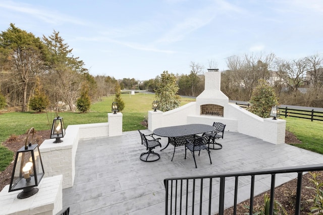 view of patio featuring an outdoor brick fireplace