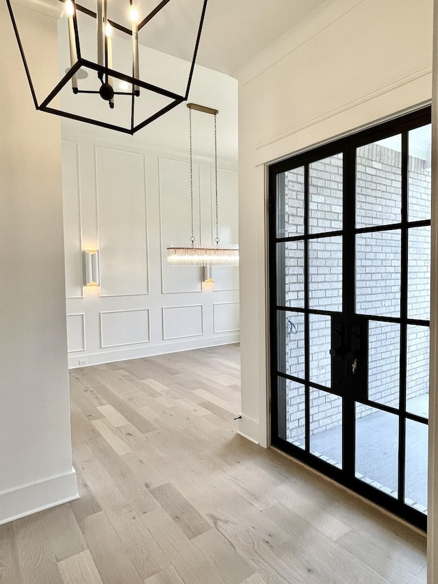 unfurnished dining area featuring light hardwood / wood-style floors and plenty of natural light