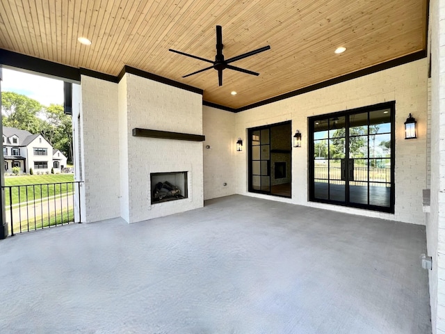 view of patio with ceiling fan and a fireplace