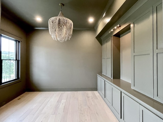 interior space featuring light hardwood / wood-style floors and an inviting chandelier