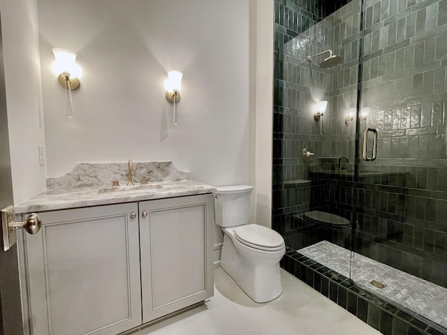 bathroom with toilet, walk in shower, and vanity