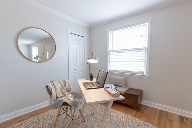 office space featuring a wealth of natural light, light hardwood / wood-style flooring, and ornamental molding