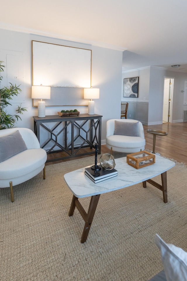 living room featuring hardwood / wood-style floors and crown molding