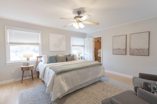 bedroom with light wood-type flooring, ceiling fan, ornamental molding, and ensuite bath