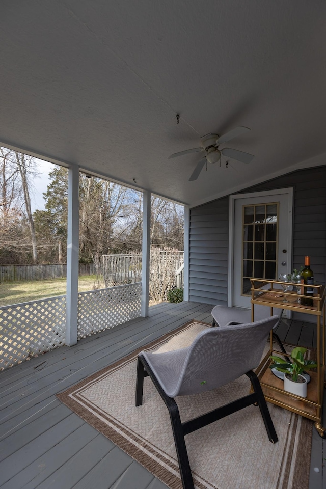 sunroom / solarium featuring ceiling fan and lofted ceiling