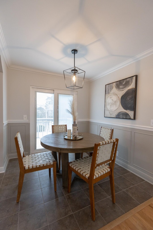 tiled dining room featuring crown molding and a chandelier