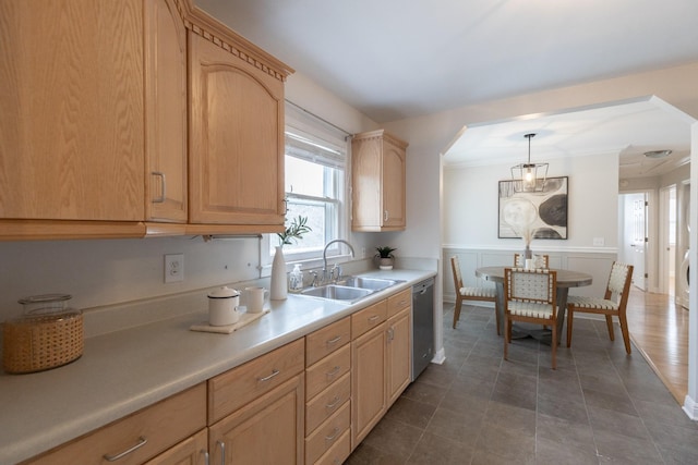 kitchen featuring sink, light brown cabinetry, pendant lighting, and stainless steel dishwasher