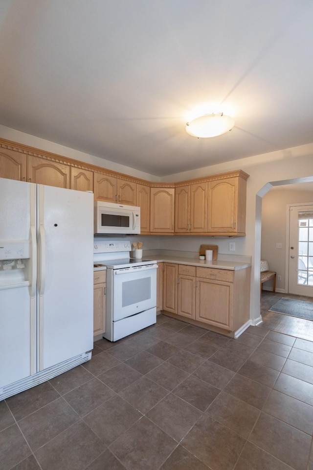 kitchen with white appliances and light brown cabinetry