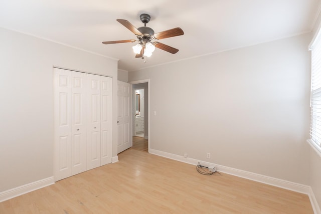 unfurnished bedroom featuring light hardwood / wood-style flooring, a closet, and ceiling fan