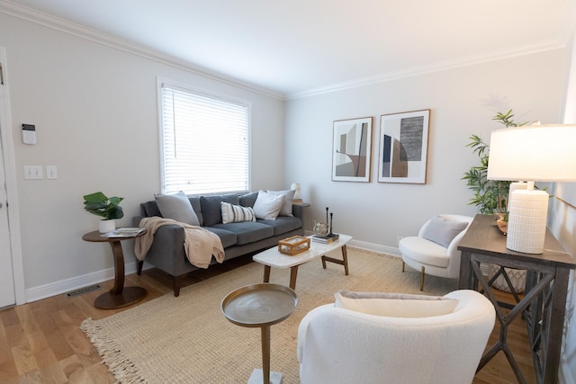 living room featuring crown molding and light hardwood / wood-style floors