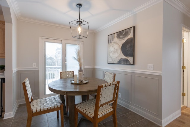 dining area with ornamental molding and dark tile patterned floors