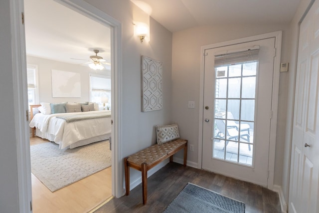 doorway to outside featuring ceiling fan, dark hardwood / wood-style flooring, and lofted ceiling