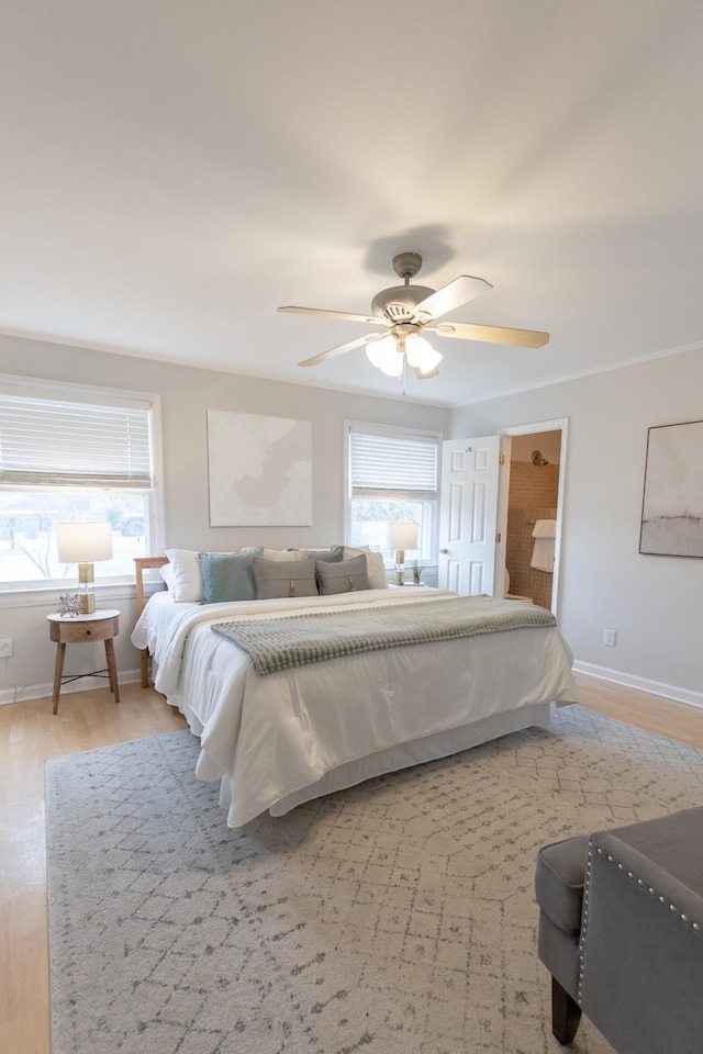 bedroom featuring ceiling fan, multiple windows, and light wood-type flooring