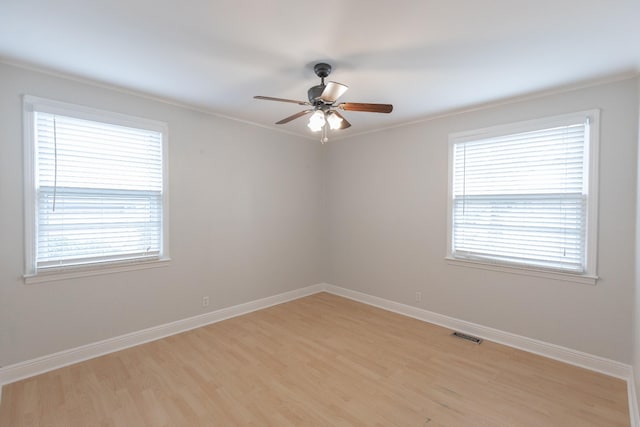 unfurnished room featuring ceiling fan, crown molding, and light hardwood / wood-style floors