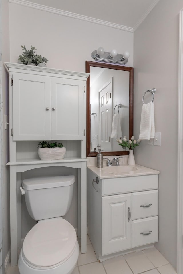 bathroom with tile patterned floors, vanity, crown molding, and toilet