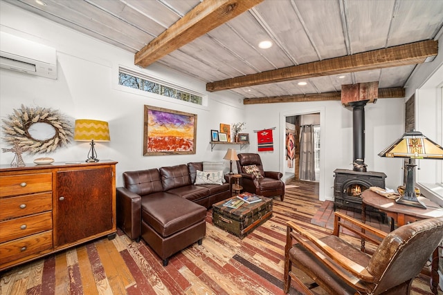 living room featuring hardwood / wood-style floors, beamed ceiling, a wood stove, a wall unit AC, and wooden ceiling