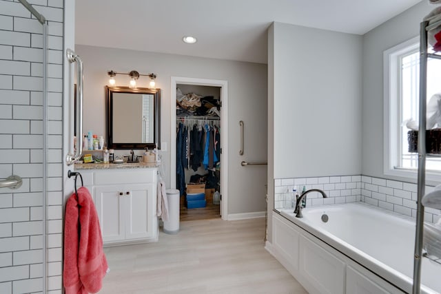 bathroom with vanity and a bathtub