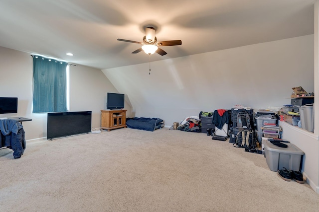 interior space with ceiling fan, carpet floors, and lofted ceiling