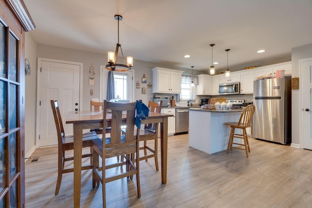 dining space with light wood-type flooring