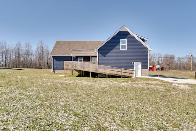 rear view of house featuring a yard and a deck