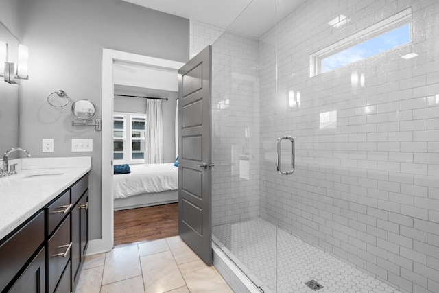 full bathroom with ensuite bathroom, a shower stall, vanity, and tile patterned floors