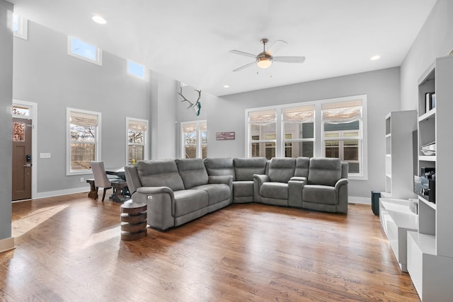 living area featuring ceiling fan, baseboards, wood finished floors, and recessed lighting