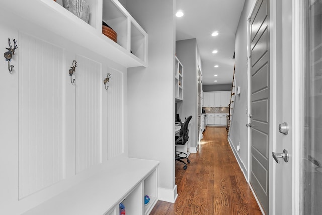 mudroom with recessed lighting, dark wood-style flooring, and baseboards