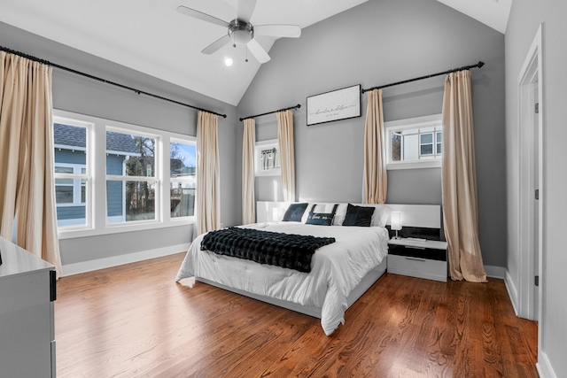 bedroom featuring a ceiling fan, lofted ceiling, baseboards, and wood finished floors