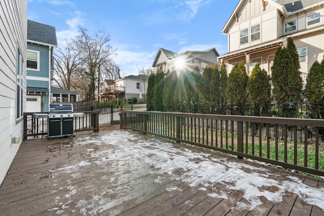 wooden deck featuring a residential view, fence, and grilling area