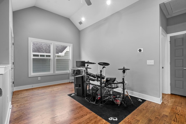 interior space with lofted ceiling, ceiling fan, wood finished floors, and baseboards