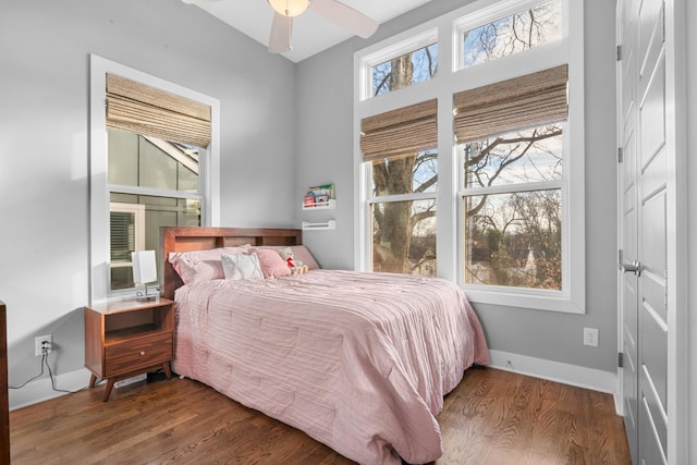 bedroom featuring baseboards and wood finished floors