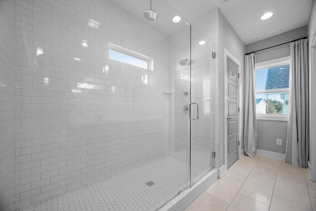 bathroom with a stall shower, tile patterned flooring, baseboards, and recessed lighting