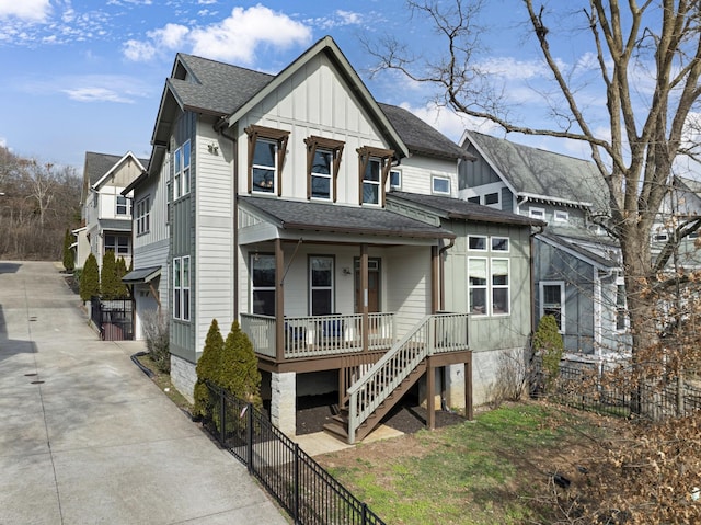 view of front of property featuring board and batten siding, roof with shingles, a porch, and fence