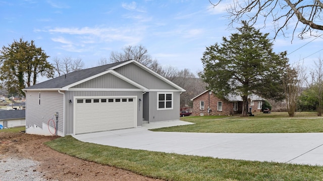 view of front of home featuring a garage and a front lawn