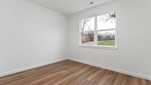 spare room with wood-type flooring