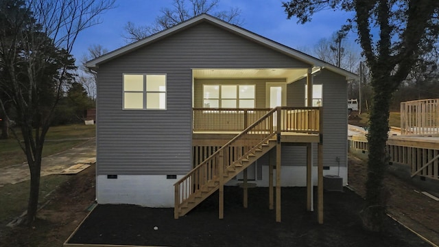 rear view of property featuring a porch and central AC