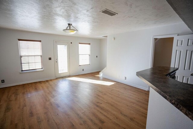 interior space with hardwood / wood-style flooring and a textured ceiling