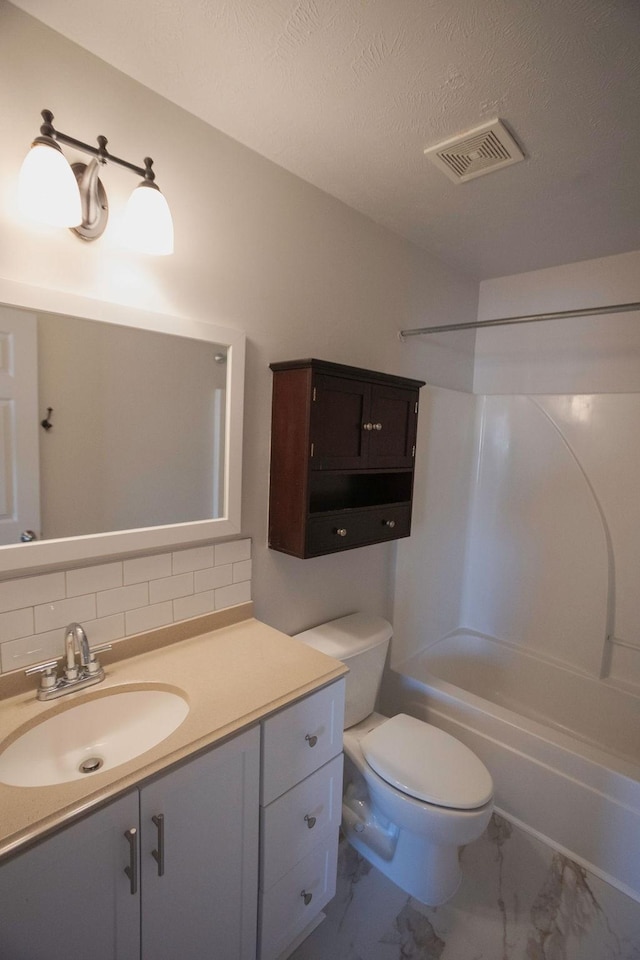 full bathroom with toilet, a textured ceiling, shower / bathing tub combination, vanity, and backsplash