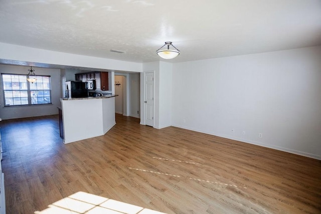 unfurnished living room with hardwood / wood-style flooring