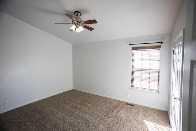 carpeted spare room featuring ceiling fan