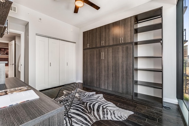 bedroom with ceiling fan, dark hardwood / wood-style floors, and a closet