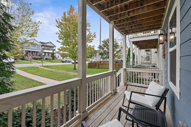 deck with a lawn and a porch