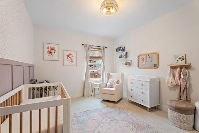 bedroom with light carpet and a crib