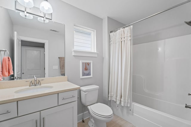 full bathroom with vanity, toilet, and shower / bath combo with shower curtain