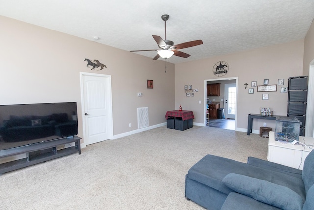 living room with ceiling fan, a textured ceiling, and carpet floors