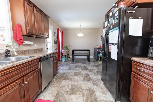 kitchen with black refrigerator with ice dispenser, decorative light fixtures, stainless steel dishwasher, and sink