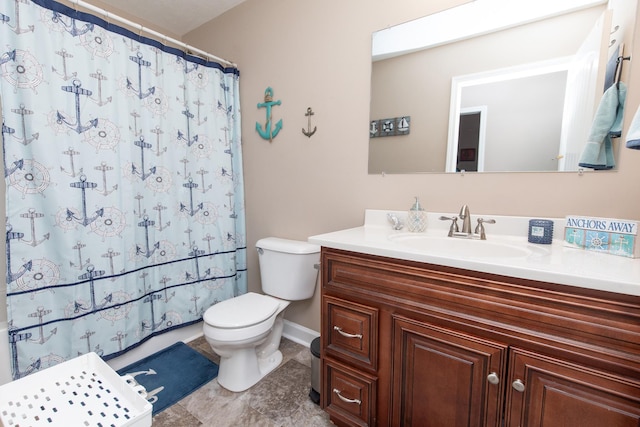 bathroom featuring vanity, toilet, and curtained shower