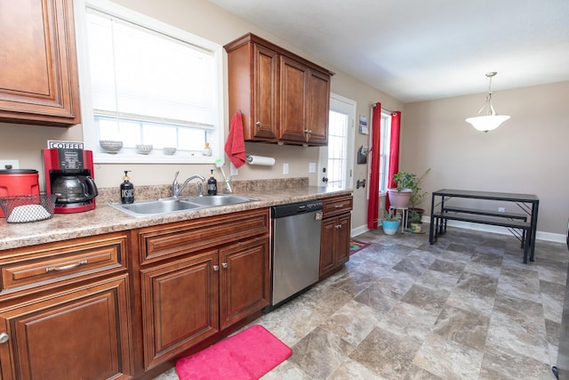 kitchen featuring sink, hanging light fixtures, and stainless steel dishwasher